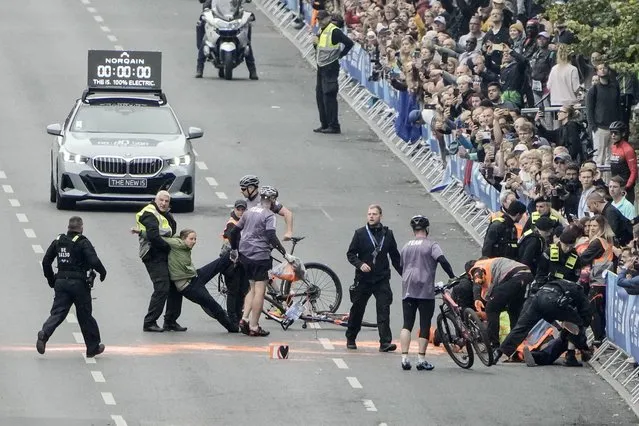 Police remove activists from the track before the start of the Berlin Marathon in Berlin, Germany, Sunday, September 24, 2023. (Photo by Markus Schreiber/AP Photo)