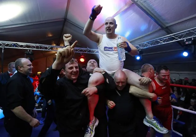 Fr Pierre Pepper is carried aloft after defeating Jared Madden during his amateur boxing match in the town of Banagher in County Offaly March 15, 2015. (Photo by Cathal McNaughton/Reuters)