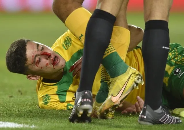 Gaston Togni of Argentina's Defensa y Justicia, lies injured on the pitch after a rough play during a Copa Sudamericana, second leg semi-final soccer match against Ecuador's Liga Deportiva Universitaria at Nestor Diaz Perez stadium in Buenos Aires, Argentina, Wednesday, October 4, 2023. (Photo by Gustavo Garello/AP Photo)