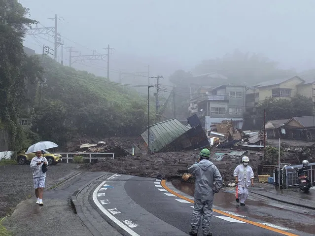 In this photo taken and provided by Satoru Watanabe, a road is covered by mud and debris following heavy rain in Atami city, Shizuoka prefecture, Saturday, July 3, 2021. A powerful mudslide carrying a deluge of black water and debris crashed into rows of houses in the same city, west of Tokyo following heavy rains on Saturday, leaving multiple people missing, officials said.(Photo by Satoru Watanabe via AP Photo)