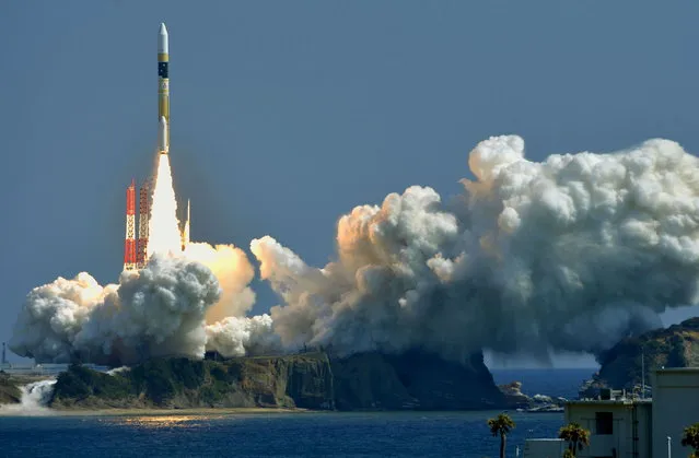 A H-IIA rocket, carrying a information gathering satellite, lifts off from the launching pad at Tanegashima Space Center on the Japanese southwestern island of Tanegashima, in this photo taken by Kyodo March 26, 2015. (Photo by Reuters/Kyodo News)