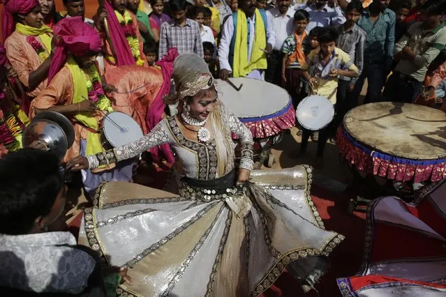 A woman dances during a religious procession on Ram Navami festival in New Delhi, India, Saturday, March 28, 2015. (Photo by Altaf Qadri/AP Photo)