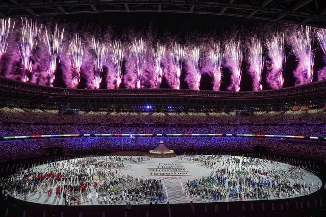 Athletes watch as Fireworks go off during the Opening Ceremony for the Tokyo 2020 Olympic Games at Tokyo Olympic Stadium on Friday, July 23. 2021. (Photo by Toni L. Sandys/The Washington Post)