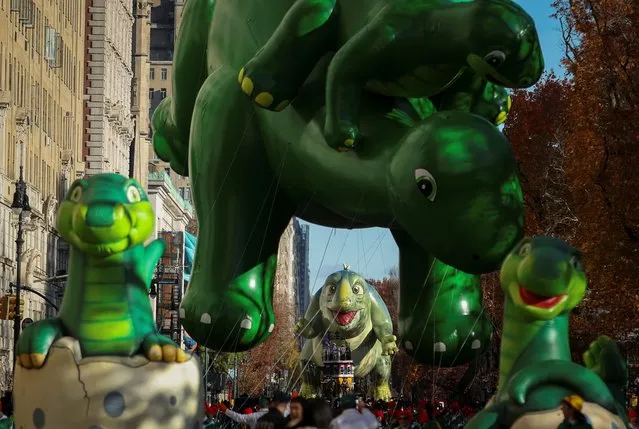 Sinclair's Dino and Leo balloons fly during the 97th Macy's Thanksgiving Day Parade in Manhattan, New York City, U.S., November 23, 2023. (Photo by Mike Segar/Reuters)