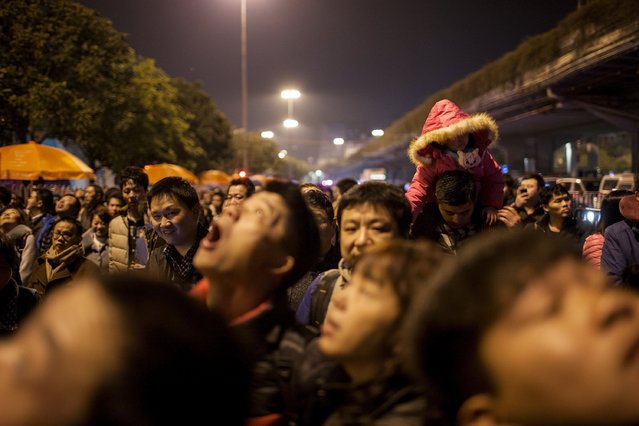 Passengers wait outside the Guangzhou Railway Station, Guangdong, China, February 3, 2016. More than 50,000 passengers were stranded at a railway station in the Chinese city of Guangzhou on Tuesday because of weather delays, state media said, an inauspicious start for some as the country embarks upon its annual lunar new year travel rush. (Photo by Zhong Ruijun/Reuters/Southern Metropolis Daily)