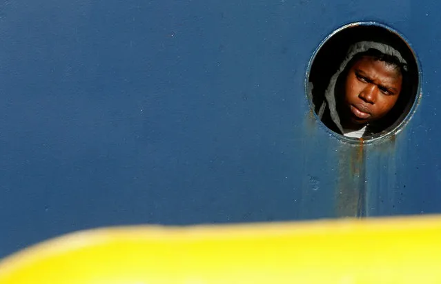 A migrant looks outside a porthole on the deck of the migrant search and rescue ship Professor Albrecht Penck, operated by German NGO Sea-Eye, off the coast of Malta, January 8, 2019. (Photo by Darrin Zammit Lupi/Reuters)