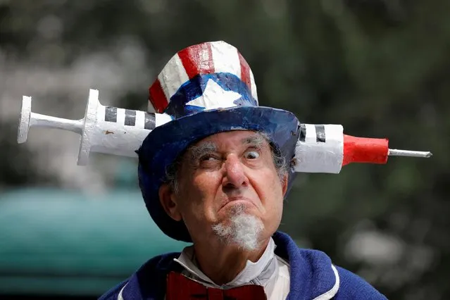 A person dressed as Uncle Sam attends an anti-mandatory coronavirus disease (COVID-19) vaccine protest held outside New York City Hall in Manhattan, New York City, U.S., August 9, 2021. (Photo by Andrew Kelly/Reuters)