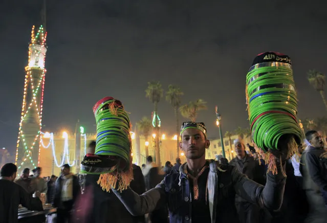A street vendor sells traditional hats as Muslims celebrate Moulid Al-Hussein, the birthday of Prophet Mohammad's grandson Hussein in old Cairo, Egypt, February 10, 2016. (Photo by Amr Abdallah Dalsh/Reuters)