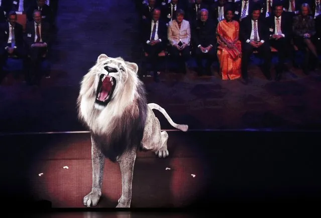 A lion is projected on a screen as German Chancellor Angela Merkel (top R row, 2nd L) and India's Prime Minister Narendra Modi attend the opening ceremony of the world's largest industrial technology fair, the Hannover Messe, in Hanover April 12, 2015. (Photo by Wolfgang Rattay/Reuters)