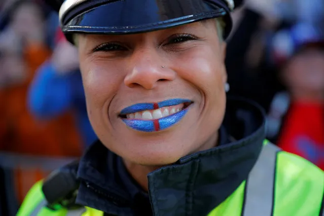 A Boston Police officer has her lips painted the colors of the New England Patriots during their victory parade after winning Super Bowl LIII, in Boston, Massachusetts, U.S., February 5, 2019. (Photo by Brian Snyder/Reuters)