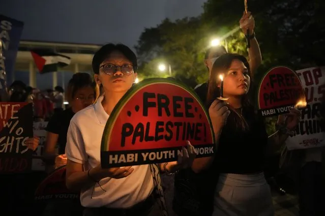 Activists hold slogans during a demonstration in support of the Palestinian people and calling for a ceasefire in Gaza as they march at the University of the Philippines in Quezon City, Philippines on Thursday November 22, 2023. (Photo by Aaron Favila/AP Photo)