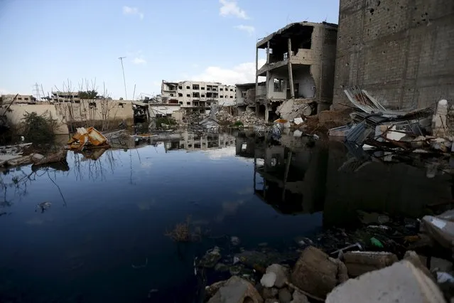 Sewage water is pictured near damaged buildings in the rebel-controlled area of Jobar, a suburb of Damascus, Syria March 3, 2016. (Photo by Bassam Khabieh/Reuters)