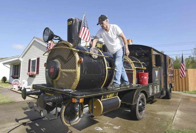 Rex Marsh washes up the V-807 Forty & Eight train vehicle on Friday morning, October 8, 2021, in front of his home in Owensboro, Ky., as he gets it ready to be in the West Side Nut Club's Fall Festival parade on Saturday in Evansville The train vehicle was built in 1934 to honor World War I veterans and has been in parades all across the country. (Photo by Alan Warren/The Messenger-Inquirer via AP Photo)