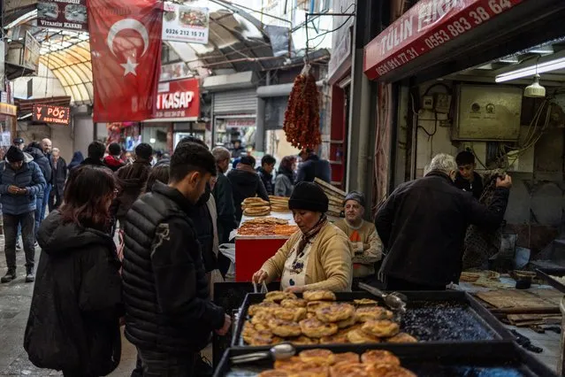 People shop in Hatay, Turkey, on February 5, 2024. (Photo by Umit Bektas/Reuters)