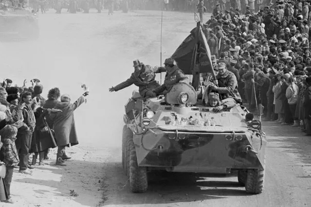 People and relatives greet Soviet Army soldiers driving on their armored personnel carriers after crossing a bridge on the border between Afghanistan and then Soviet Uzbekistan near the Uzbek town of Termez, Uzbekistan in February 15, 1989. After nearly a decade of fighting in Afghanistan, he ordered the withdrawal of Soviet troops in 1989, entered into multiple arms control and disarmament agreements with the United States and other countries, and helped end the Cold War. (Photo by Alexander Zemlianichenko/AP Photo/File)