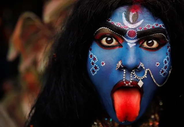 An Indian woman dressed as Hindu Goddess Kali participates in a “Shivratri” procession in Allahabad, India, Thursday, Feb. 27, 2014. “Shivaratri”, or the night of Shiva, is dedicated to the worship of Lord Shiva, the Hindu god of death and destruction. (Photo by Rajesh Kumar SinghAP Photo)