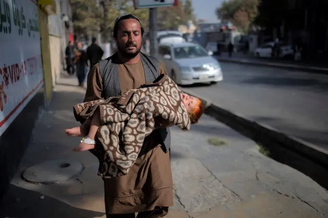 A man hurries away after an explosion Tuesday, November 2, 2021. (Photo by Ahmad Halabisaz/AP Photo)