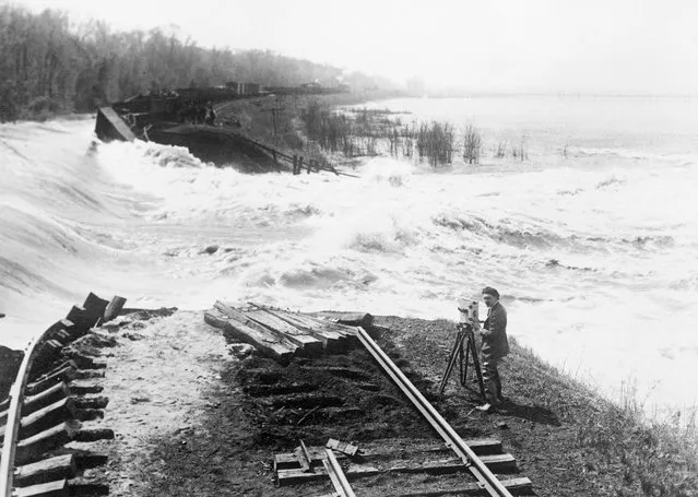 Thirty foot all of water raging towards beardstown, Illinois as the levee broke under the tremendous pressure on April 18, 1922. The Illinois River at flood stage, the highest ever known rapidly poured in the lowlands at the right. In foreground are the C.B. & Q. railroad tracks. The last connecting link between Beardstown and the outside world, just washed away. Photo was taken by Norman W. Alley of International Newsreel Staff. (Photo by Bettmann Archive)