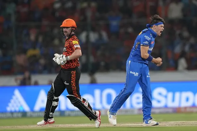 Mumbai Indians' Gerald Coetzee, right, celebrates the dismissal of Sunrisers Hyderabad's Travis Head, left, during the Indian Premier League cricket tournament between Sunrisers Hyderabad and Mumbai Indians in Hyderabad, India, Wednesday, March 27, 2024. (Photo by Mahesh Kumar A./AP Photo)