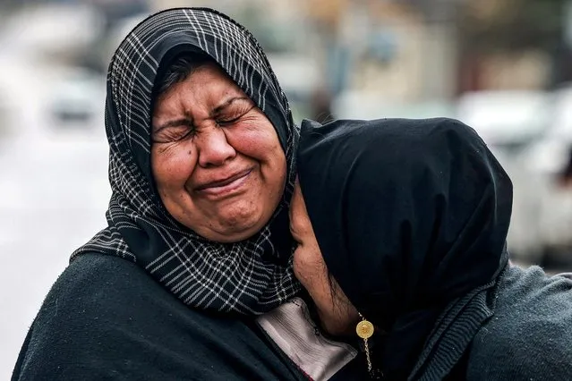 Two women embrace as they react while mourning relatives who were killed during Israeli bombardment late the previous night, at al-Najar Hospital in Rafah in the southern Gaza Strip on March 19, 2024 amid the ongoing conflict in the Palestinian territory between Israel and the militant group Hamas. (Photo by Mohammed Abed/AFP Photo)