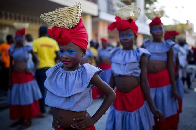 Performers stand during a pause on the Carnival parade route in Les Cayes, Haiti, Monday, February 27, 2017. (Photo by Dieu Nalio Chery/AP Photo)