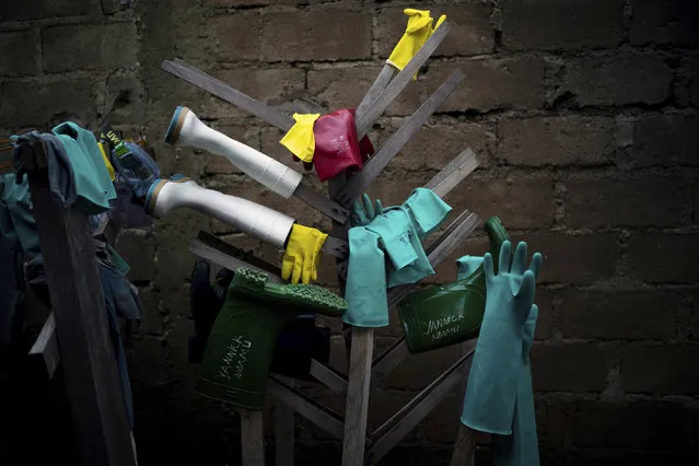 In this Friday, July 12, 2019 photo, rubber gloves and boots used by health workers treating Ebola patients are hung to dry after being disinfected at an Ebola treatment center in Beni, Congo. The World Health Organization says as many as 90 percent of those eligible for vaccination have accepted it, but that figure only includes those who gave contact tracers enough information to be included on a list. The success rate excludes those who distrusted health workers and fled, or those who couldn’t be found in the first place. (Photo by Jerome Delay/AP Photo)