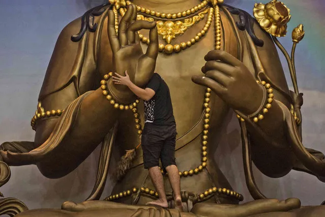 A worker cleans a Buddha statue in preparation for the Lunar New Year celebrations at Satya Buddha Temple in Medan, North Sumatra, Indonesia, Wednesday, January 19, 2022. Chinese people around the world will be celebrating the beginning of the Year of Tiger on Feb. 1. (Photo by Binsar Bakkara/AP Photo)