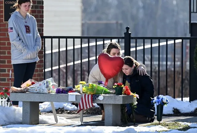 Students Madison Creason, left to right, Bridget O’Donnell and Morgan Taylor pay their respects at a makeshift memorial for safety Officer J.J. Jefferson and police Officer John Painter at Bridgewater College on Wednesday February 02, 2022 in Bridgewater, VA. A shooting at the college on Tuesday killed Jefferson and Painter. (Photo by Matt McClain/The Washington Post)