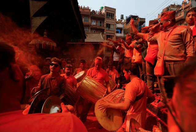 Devotees play traditional musical instruments as they celebrate “Sindoor Jatra” vermillion powder festival to welcome the arrival of spring and Nepali New Year at Thimi in Bhaktapur, Nepal, on April 14, 2024. (Photo by Navesh Chitrakar/Reuters)