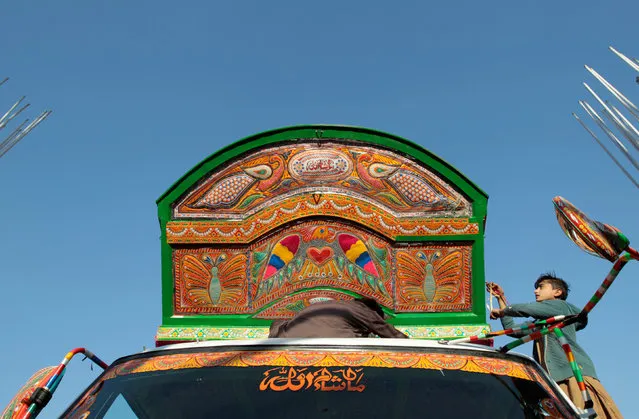 A boy works on the decoration of a truck at a workshop in Rawalpindi, Pakistan February 22, 2017. (Photo by Caren Firouz/Reuters)