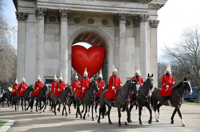 Members of the Household Cavalry walk past Wellington Arch and a large inflatable heart, on Valentine's Day in London, Britain, February 14, 2022. (Photo by Peter Nicholls/Reuters)