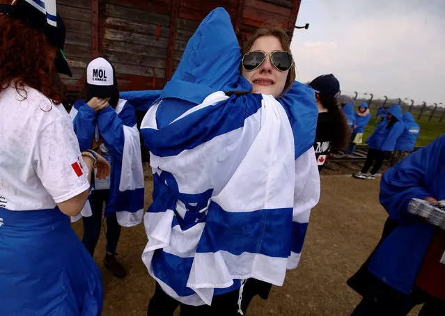 Women hug in the former Nazi death camp of Auschwitz-Birkenau (Auschwitz II) as thousands of people, mostly youth from all over the world gathered for the annual “March of the Living” to commemorate the Holocaust in Brzezinka near Oswiecim, Poland May 5, 2016. (Photo by Kacper Pempel/Reuters)