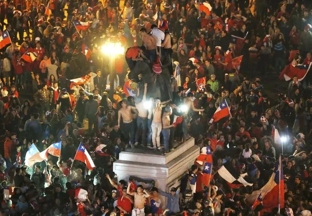 Chilean fans celebrate their team defeating Argentina to win the Copa America 2015 final soccer match at the National Stadium in Santiago, Chile, July 4, 2015. (Photo by Carlos Garcia Rawlins/Reuters)