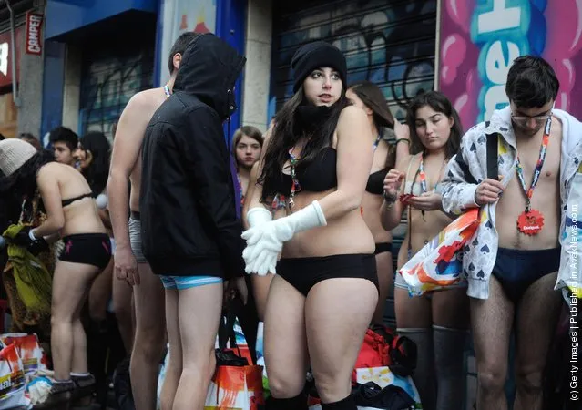 Semi-nude shoppers queue for free clothes during a promotion by a Spanish clothes outlet on January in Madrid