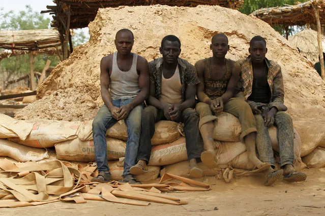 Miners pose for a picture as they take a break and sit on bagged soil at a miners settlement in Anka, Zamfara, Nigeria, April 21, 2016. (Photo by Afolabi Sotunde/Reuters)