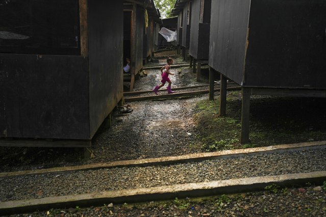 A Venezuelan migrant child runs through a temporary camp after walking across the Darien Gap from Colombia, in Lajas Blancas, Panama, Friday, June 28, 2024. (Photo by Matias Delacroix/AP Photo)