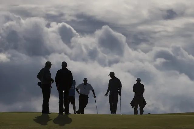 Tiger Woods of the United States, second right, walks across the 11th green during a practice round at St Andrews Golf Club prior to the start of the British Open Golf Championship, in St. Andrews, Scotland, Monday, July 13, 2015. (Photo by Jon Super/AP Photo)