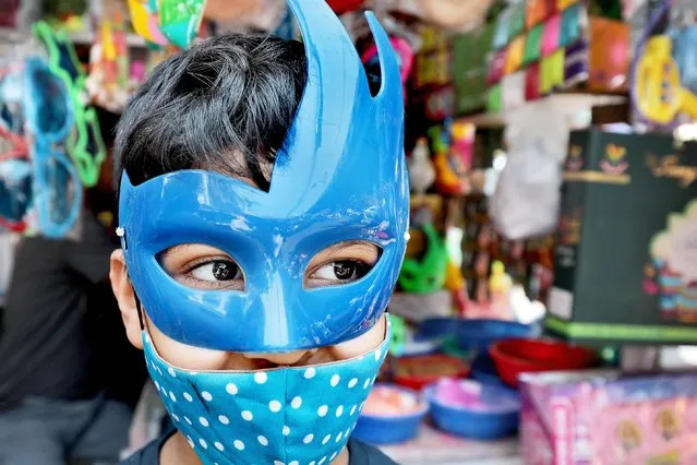 A boy wears a mask ahead of the Holi celebrations in Kolkata, India, 15 March 2022. Holi is an ancient Indian festival to mark the arrival of spring. This year, the main Holi celebrations will take place on 18 March 2020. (Photo by Piyal Adhikary/EPA/EFE)