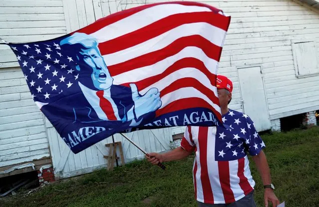 Trump supporter Don Bowen waves a Trump flag outside the 2019 Presidential Galivants Ferry Stump Meeting in Galivants Ferry, South Carolina, U.S., September 16, 2019. (Photo by Randall Hill/Reuters)