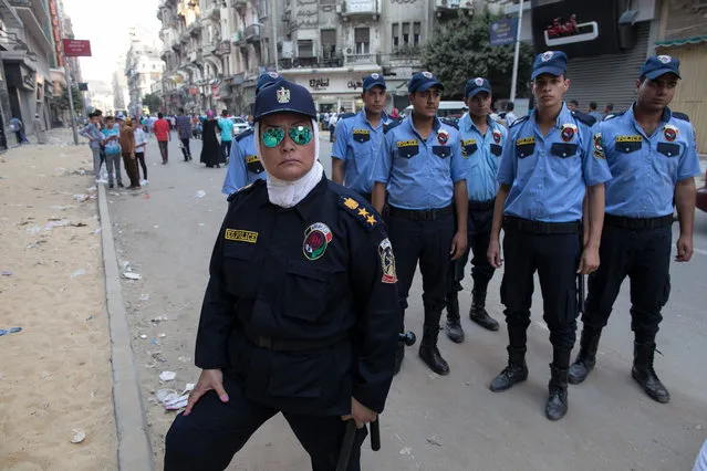 An Egyptian policewoman, part of a new anti-harassment force, stands guard in Cairo on the first day of Eid Al-Fitr,  Friday, July 17, 2015. The force is a new initiative by the Ministry of Interior to combat sexual harassment in the streets, which in past years has spiked in Cairo during the holiday celebrations with the crowds of rowdy men in the streets. (Photo by Roger Anis/AP Photo)