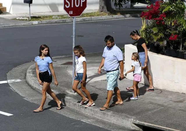 Vasyl Prishchak, center, of Kyiv, Ukraine, walks with his wife, Marina, right, and daughters, Ksenia, 5, second from right, Sofiia, 10, second from left, and Mariia, 16, left, in Kailua, Hawaii, Wednesday, March 23, 2022. The Prishchak family travelled to Hawaii for a long-awaited vacation on Feb. 16 and planned to return to Ukraine on March 7. But a week into their vacation, Russia invaded their country, leaving the family in shocked disbelief with no access to family, friends, money or their home. (Photo by Caleb Jones/AP Photo)