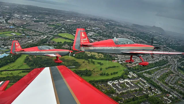 Pilots from The Royal Jordanian Falcons fly over Edinburgh ahead of taking part in Scotlands National Airshow on July 22, 2015 in Edinburgh, Scotland. The Royal Jordanian Falcons, the national aerobatic demonstration team of the Hashemite Kingdom of Jordan, will pay their first visit to East Fortune, East Lothian this year to display at Scotlands National Airshow at the National Museum of Flight on Saturday 25 July. (Photo by Jeff J. Mitchell/Getty Images)