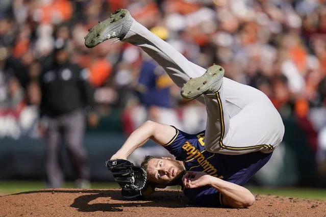 Milwaukee Brewers starting pitcher Adrian Houser rolls on his back after catching a ball hit by Baltimore Orioles' Austin Hays during the fourth inning of a baseball game at Oriole Park at Camden Yards, Monday, April 11, 2022, in Baltimore. (Photo by Julio Cortez/AP Photo)