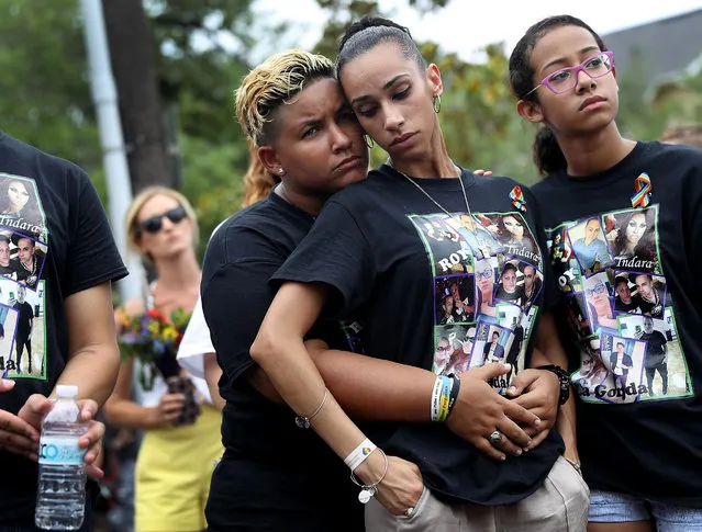 Angel Ayala (L) and Carla Montanez mourn the loss of their best friend in the mass shooting at the Pulse gay nightclub as people gather together outside the club during a one-year anniversary memorial service on June 12, 2017 in Orlando, Florida. Omar Mateen killed 49 people and wounded 53 before being killed himself by police in a shootout at the club a little after 2 a.m. on June 12, 2016. (Photo by Joe Raedle/Getty Images)