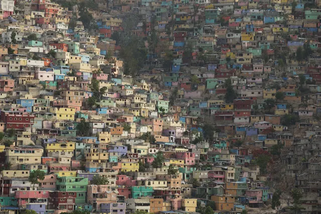 In this June 29, 2015 photo, houses pack a hillside in the Jalousie district of Port-au-Prince, Haiti. Haiti suffered from a severe housing shortage even before the 2010 earthquake. According to a January 2015 report by Amnesty International, the earthquake further increased the deficit. Meanwhile reconstruction efforts focused on building temporary shelters over permanent housing. (Photo by Rebecca Blackwell/AP Photo)