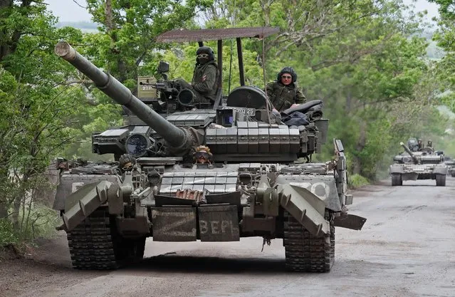 Service members of pro-Russian troops drive a tank during Ukraine-Russia conflict in the Donetsk Region, Ukraine on May 22, 2022. (Photo by Alexander Ermochenko/Reuters)