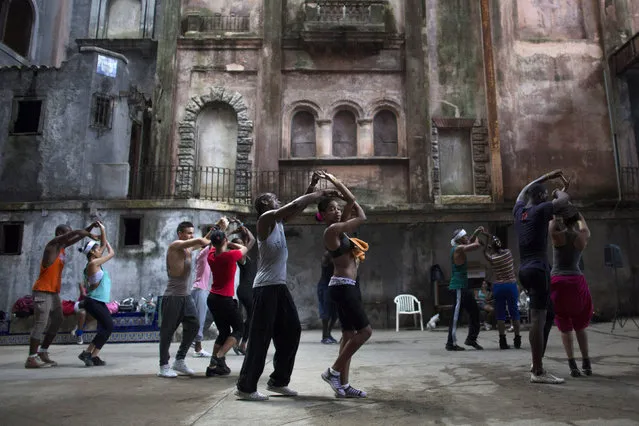 Dancers from the Deep Roots Dance Company perform during a training session in an old theatre in downtown Havana, October 14, 2014. (Photo by Alexandre Meneghini/Reuters)