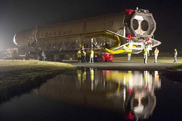 The Orbital Sciences Corporation Antares rocket, with the Cygnus spacecraft onboard, is rolled out of the Horizontal Integration Facility (HIF) to the launch pad on July 10, 2014, at NASA's Wallops Flight Facility, Wallops Island, Virginia. The Antares will launch with the Cygnus spacecraft filled with over 3,000 pounds of supplies for the International Space Station, including science experiments, experiment hardware, spare parts, and crew provisions. (Photo by Bill Ingalls/NASA via Getty Images)