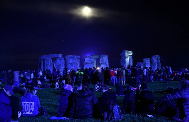 People gather at Stonehenge in Wiltshire, Britain, on June 21, 2016 to see in the new dawn. (Photo by Andrew Matthews/PA Wire)
