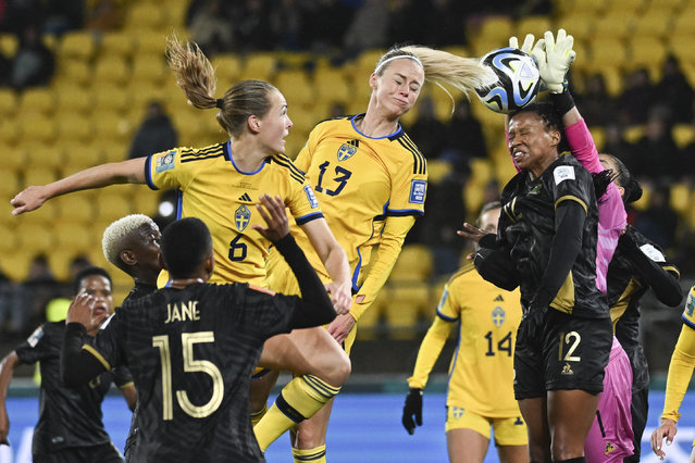 Sweden's Amanda Ilestedt heads the ball into the hands of South Africa's goalkeeper Kaylin Swart during the Women's World Cup Group G soccer match between Sweden and South Africa in Wellington, New Zealand, Sunday, July 23, 2023. (Photo by Andrew Cornaga/AP Photo)